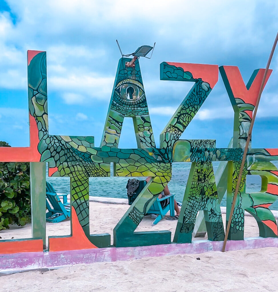 brightly-painted-lazy-lizard-bar-and-grill-sign-in-front-of-caribbean-sea-belize