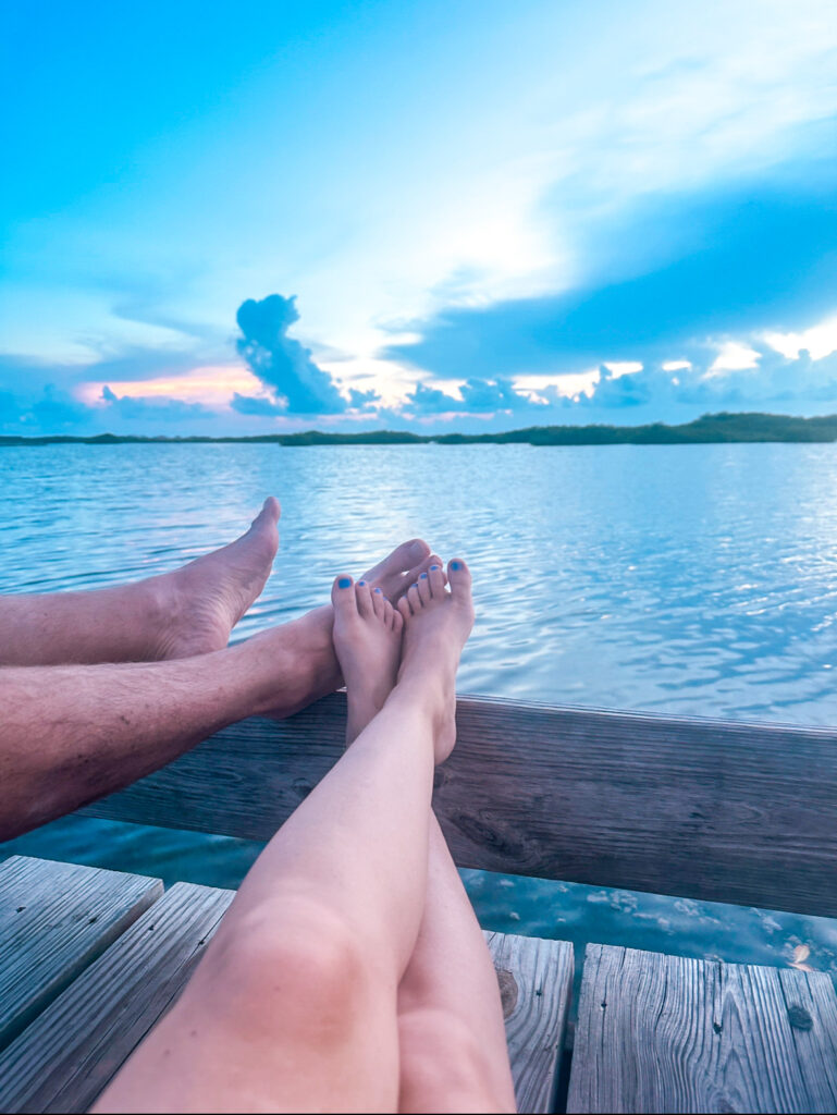 husband-and-wifes-feet-at-sunset-over-water-san-pedro-belize