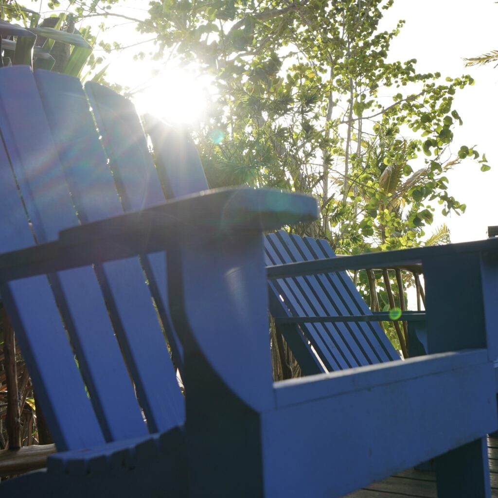 blue-lounge-chairs-on-pool-deck-with-sunshine-at-azure-del-mar