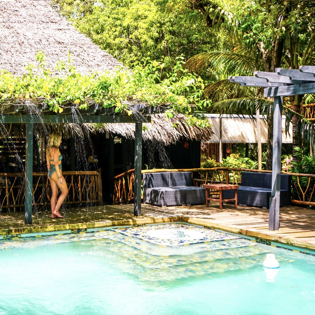 blonde-woman-walking-to-pool-at-belize-resort-azure-del-mar