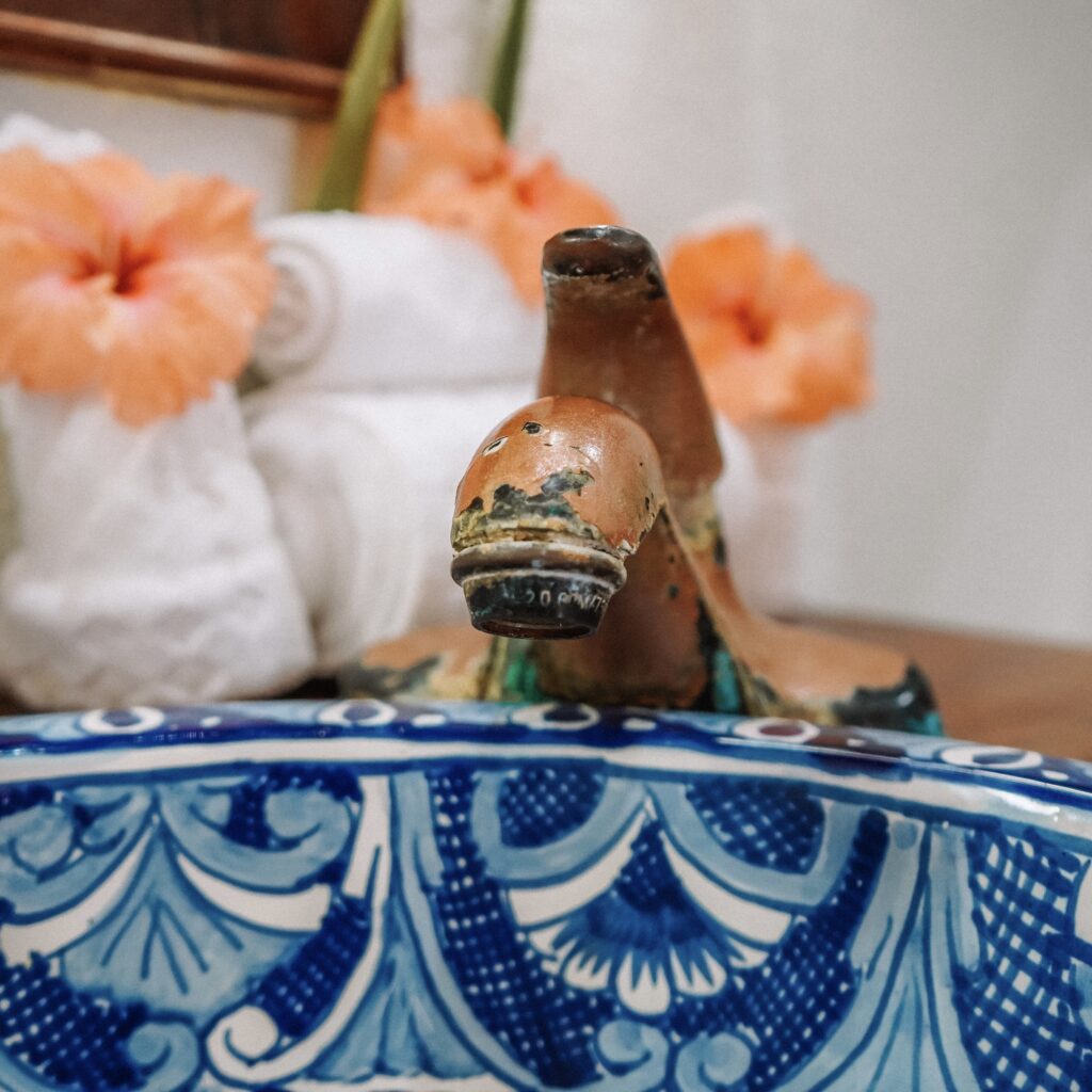 brightly-colored-Talavera-sink-with-hibiscus-flowers-at-azure-del-mar-placencia-cabanas