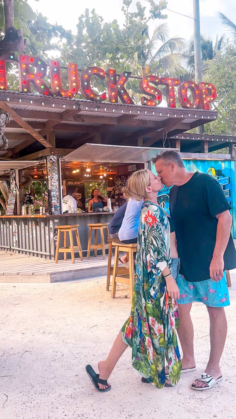 blonde-woman-and-man-kissing-at-the-truck-stop-ambergris-caye-belize