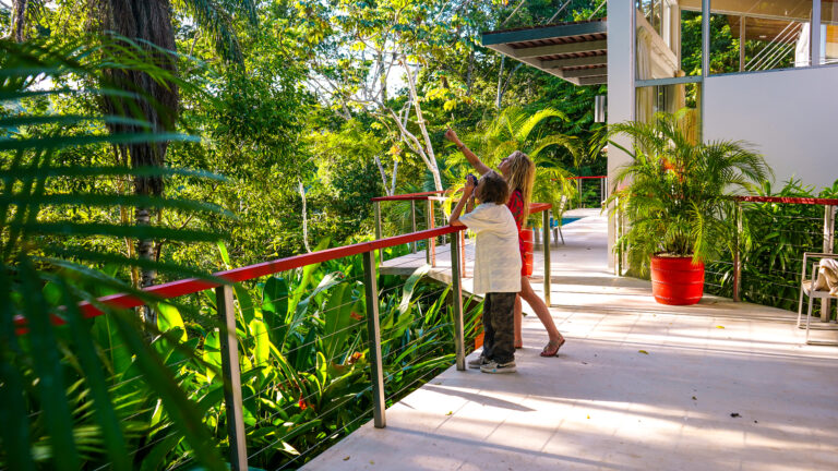 Travel writer Jenny White and her son Kai looking out into the Belize jungle at Chaa Creek Resort