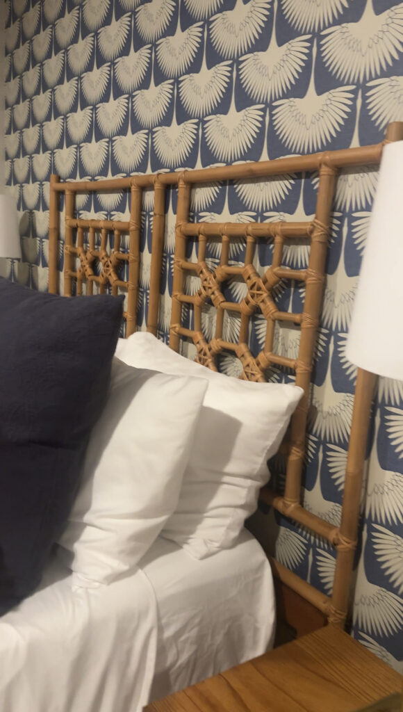 beach-inspired-rataan-bedroom-set-in-front-of-blue-wallpaper-in-gloucester-airbnb
