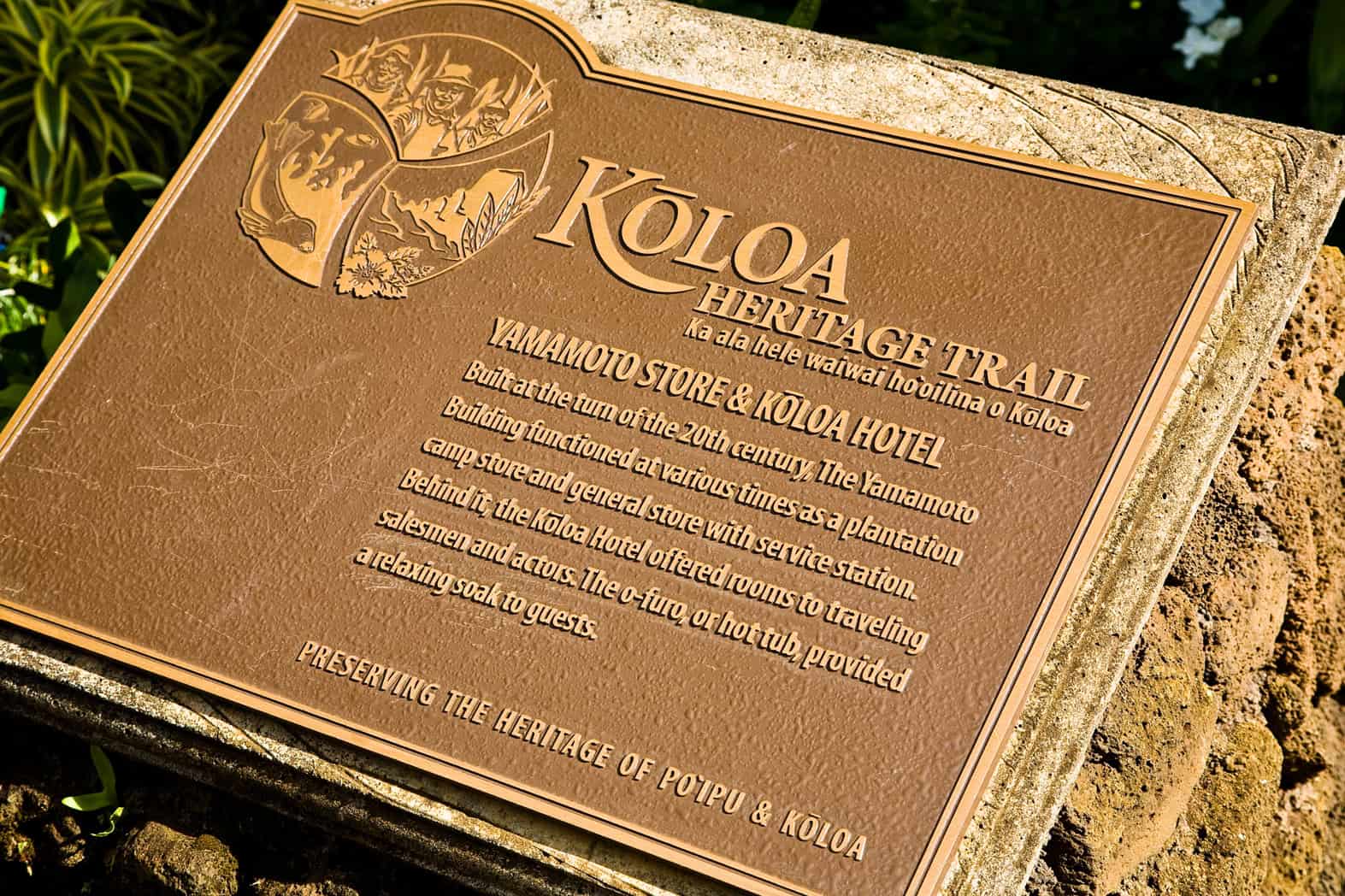 A sign that says Koloa Heritage Trail on it, explaining the significance