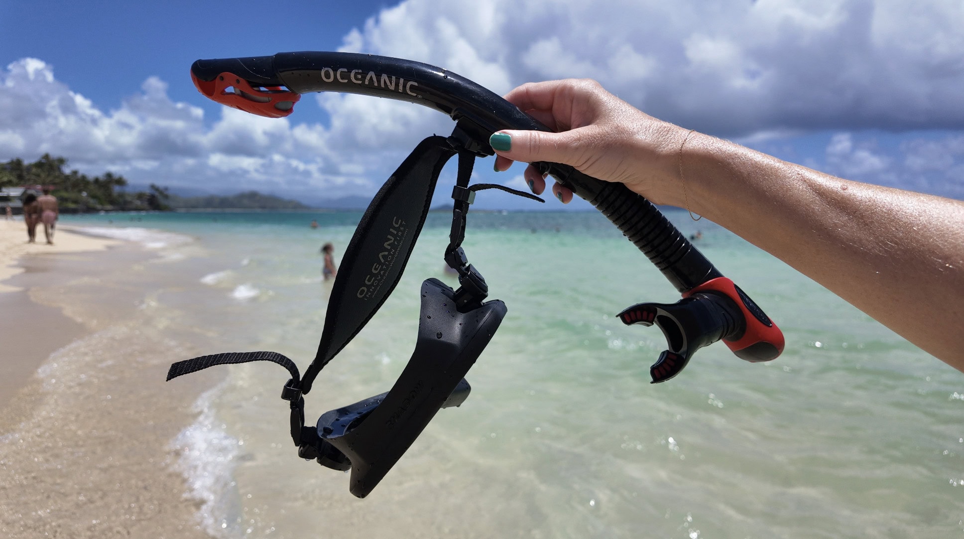 A woman holding a snorkel on Lanikai Beach in Oʻahu
