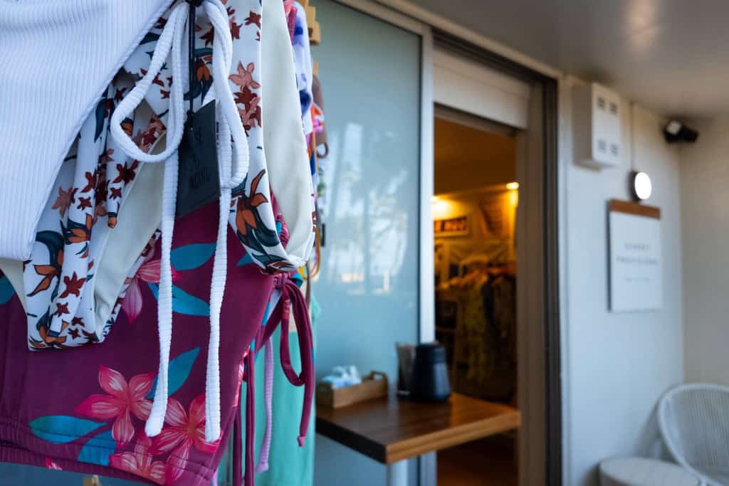 Bathing suits hanging outside a coffee shop and boutique