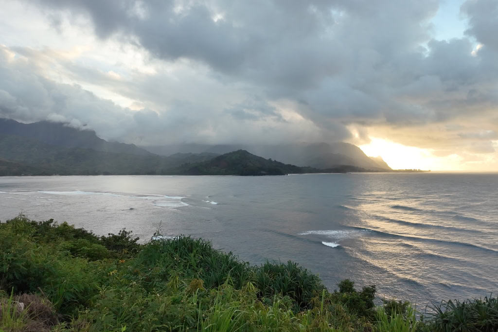 Rain and a sunset in the distance looking towards the north shore from Hanalei Bay