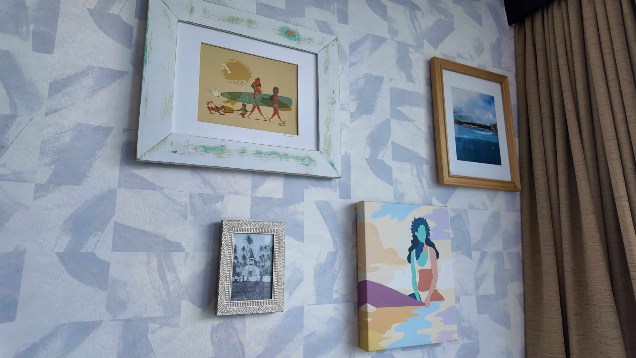 Tropical artwork on a blue and white pattern wallpaper wall