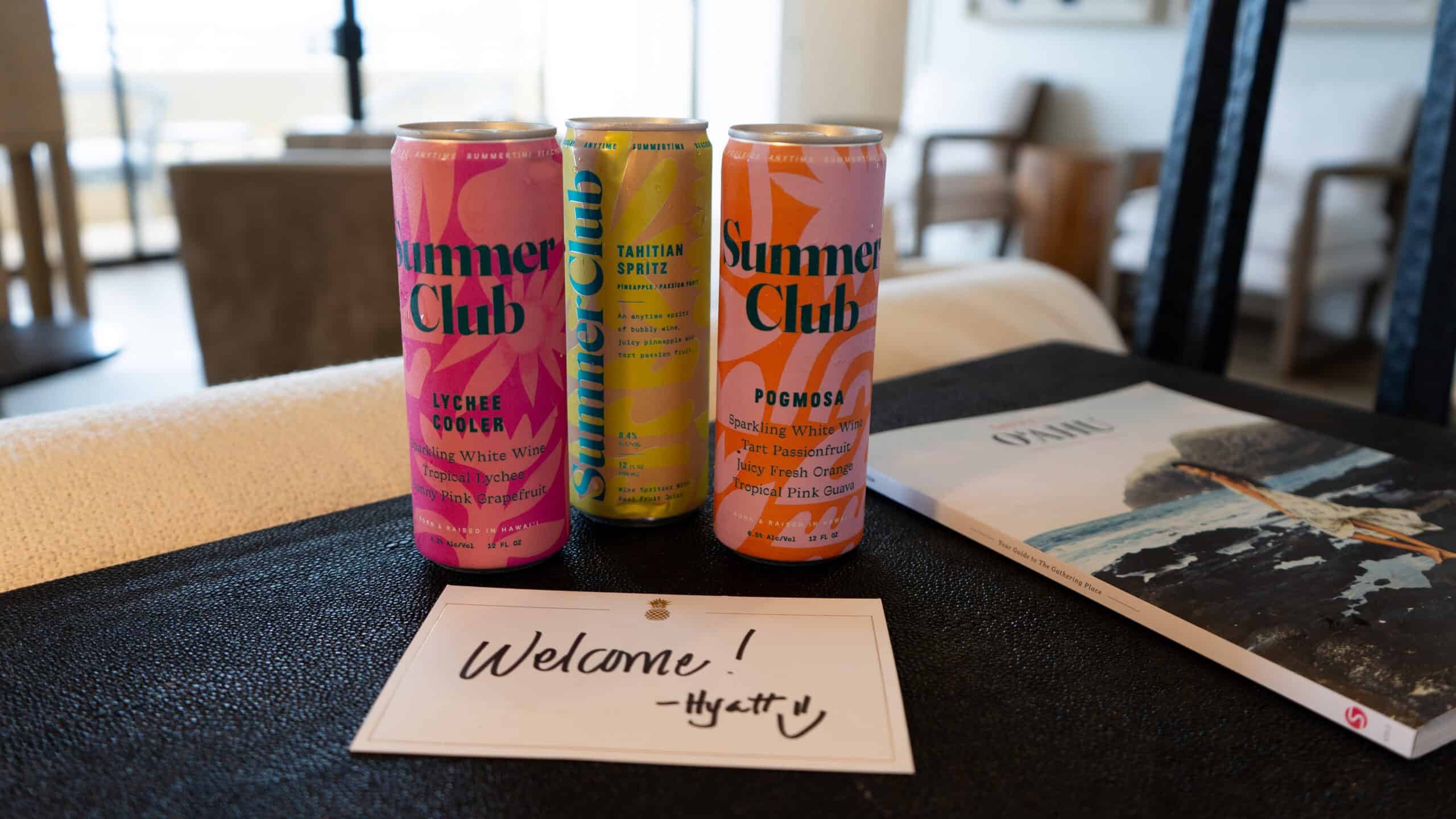 Three cans of Summer Club with a note saying Welcome