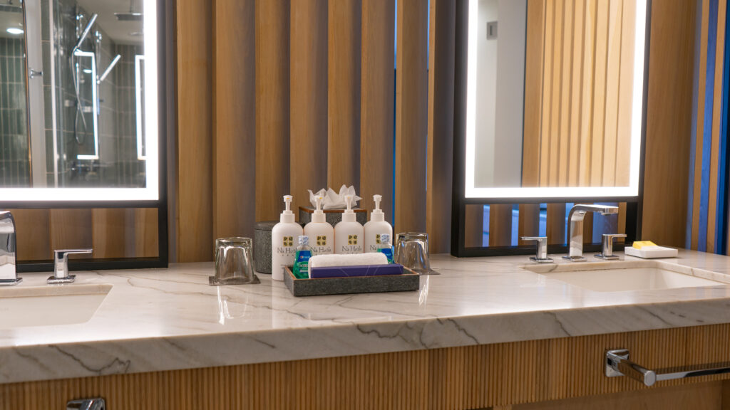 Spa products on a hotel bathroom countertop with a toothbrush kit