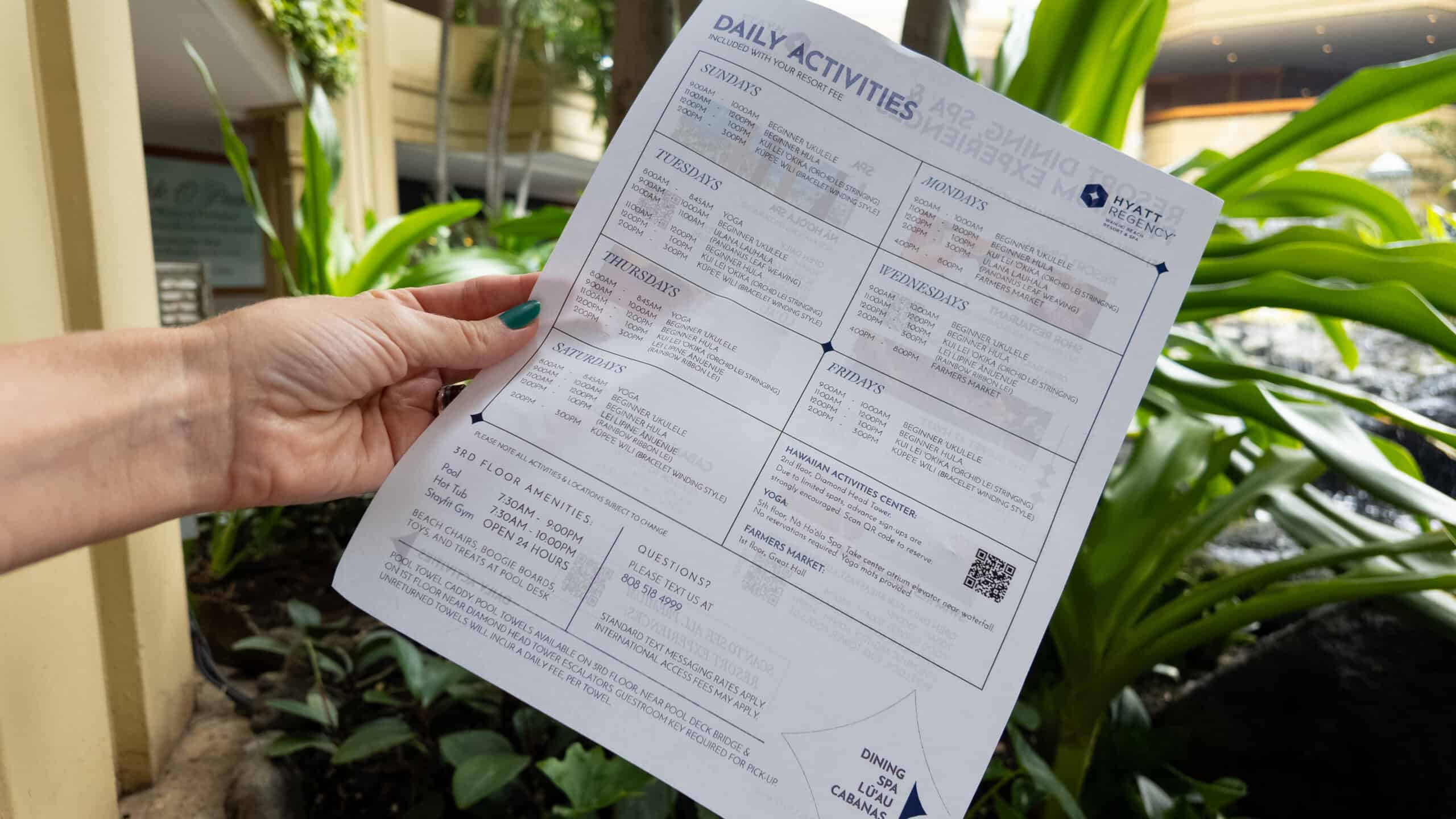 A calendar of activities at Hyatt Regency Waikiki Beach Resort with tropical plants in the background.