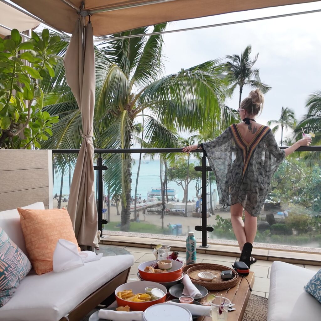 A blonde woman looking out towards Waikiki Beach