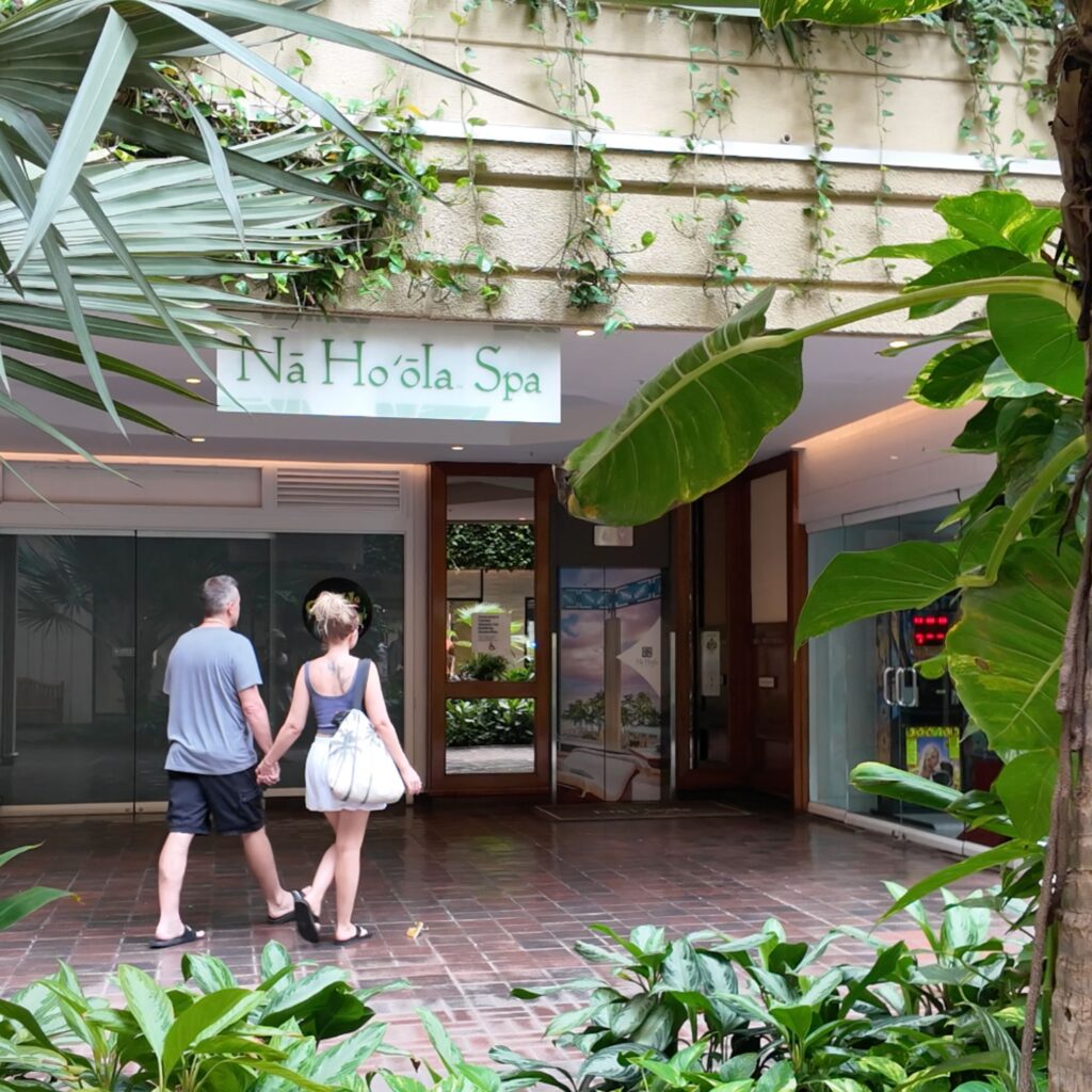 A man and woman walking into Na Ho’ola Spa