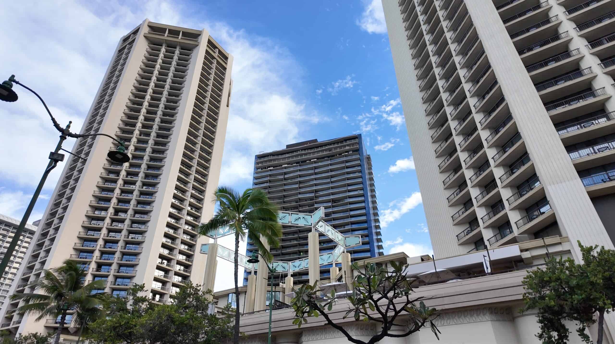 Tall hotel buildings with palm trees in the foreground in Waikiki