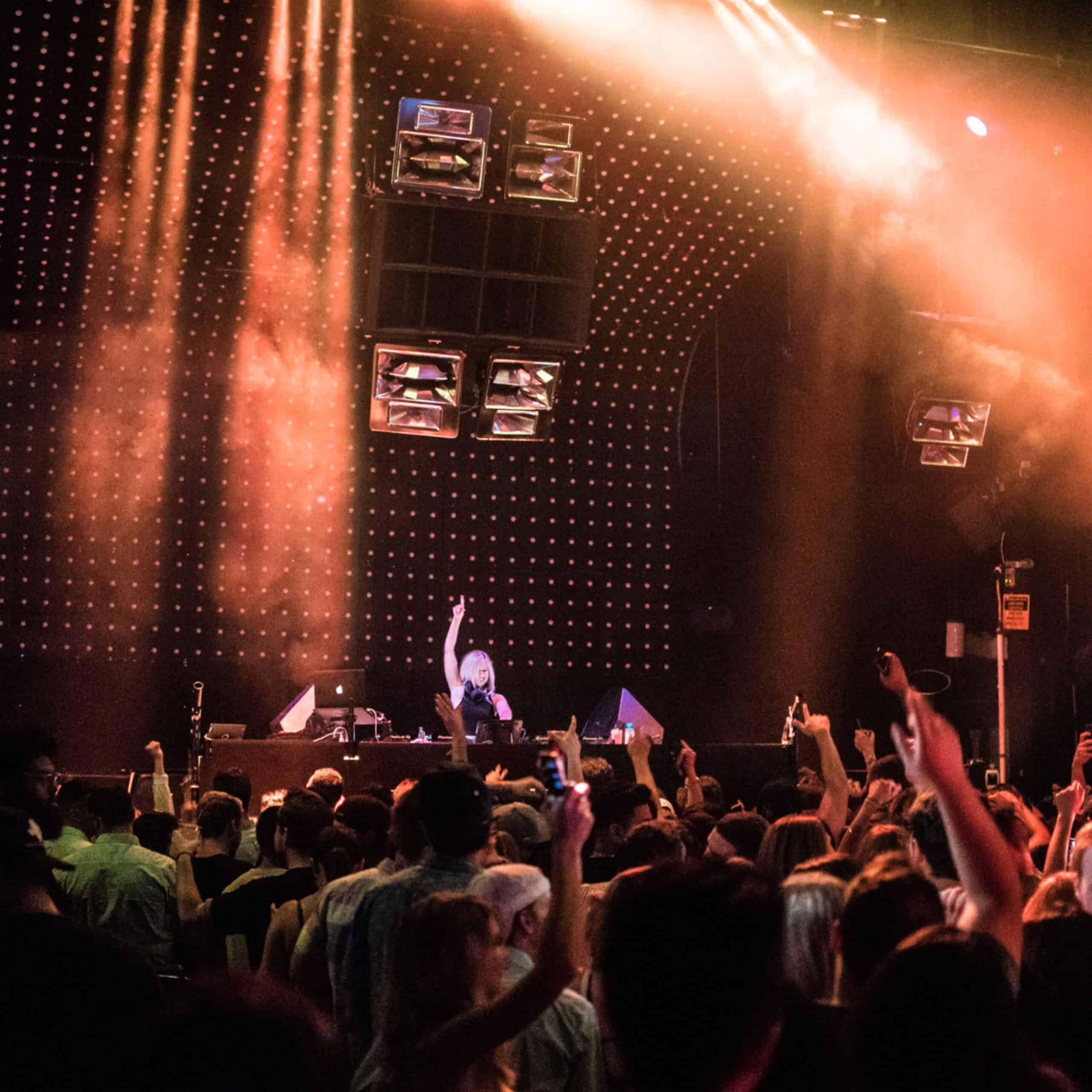 DJ J|Adore on stage in Denver Colorado with a room full of people dancing