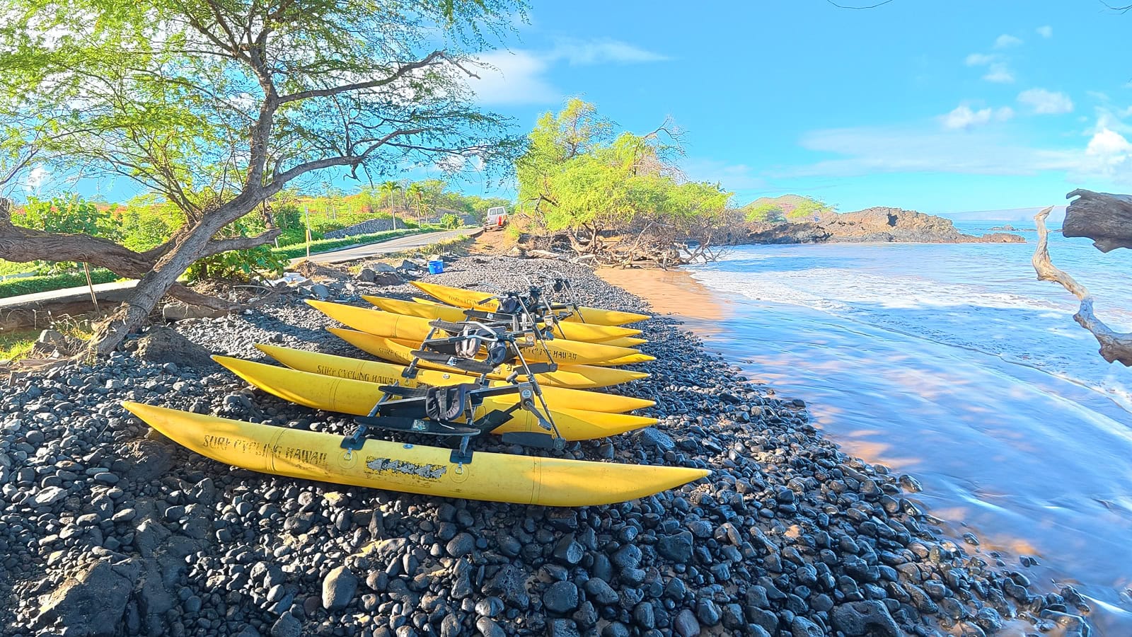 A line of Surf Cycling yellow water bikes waiting to head out to Makena Bay in South Maui