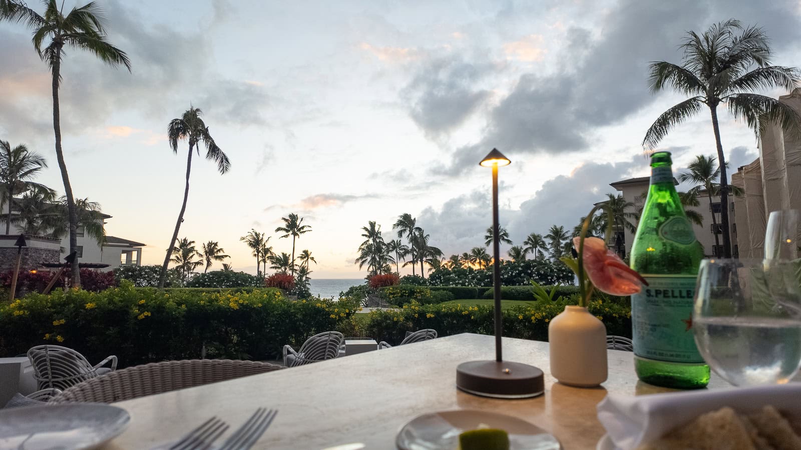 Dinner al fresco at The Restaurant at Kapalua Bay, looking out towards Kapalua Bay during a cloudy sunset