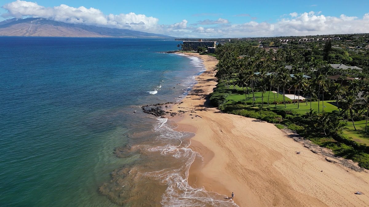 An aerial view of Keawakapu Beach on the South Side of Maui on a clear day, looking towards Mauna Kahalawai